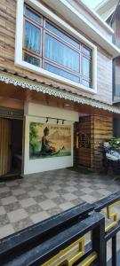 a building with a movie poster on the side of it at Cosmic Buddha Bnb in Gangtok