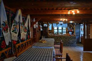 a dining room with two tables and a bar at Cabana Victor in Sighetu Marmaţiei