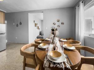a dining room with a wooden table and chairs at Casa Cueva Beach House for 14 PPL in Arecibo in Arecibo +15 photos