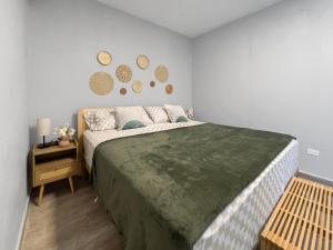 a bedroom with a large bed and a night stand at Casa Cueva Beach House for 14 PPL in Arecibo in Arecibo