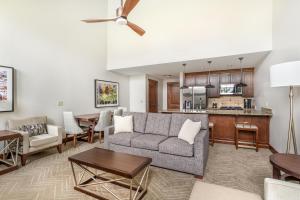 a living room with a couch and a kitchen at Hilton Grand Vacations Club Sunrise Lodge Park City in Park City