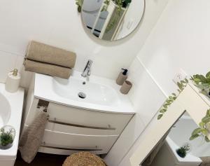 a bathroom with a sink and a mirror at Appartement Cocooning Béziers Cœur historique, charme et confort noté 10 in Béziers +27 photos
