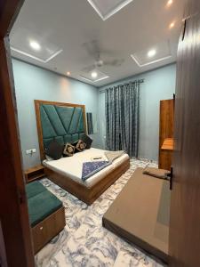 a bedroom with a bed and a couch in it at Sodhi Residency in Amritsar