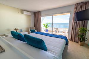 a bedroom with a large bed with a view of the ocean at Apartamentos La Jabega in Fuengirola +128 photos