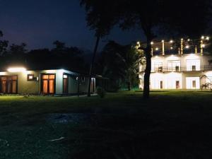 a house at night with lights in front of it at Wewlekam Safari Resort 