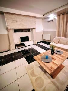 a living room with a table and a fireplace at La maison du château in Saint-Victurnien