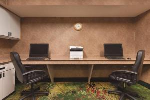 two computers sitting on a desk with two chairs at Comfort Inn & Suites Portland - Corpus Christi in Portland +6 photos