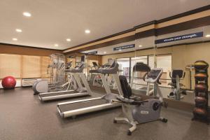 a gym with several treadmills and cardio machines at Comfort Inn & Suites Portland - Corpus Christi in Portland