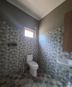 a bathroom with a toilet and a sink at Bumbab House by Pigeon in Nusa Dua +7 photos