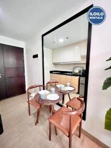 een eetkamer met een tafel en stoelen en een keuken bij Relax Stay at One Madison Tower in Cari Mayor