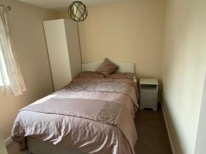 a small bedroom with a bed and a night stand at Friars terrace in Stafford