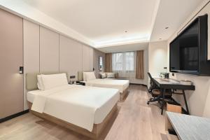 Postel nebo postele na pokoji v ubytování Atour Hotel Dalian Zhongshan Square