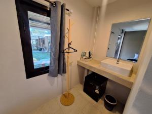 a bathroom with a sink and a mirror at So Good in Pai