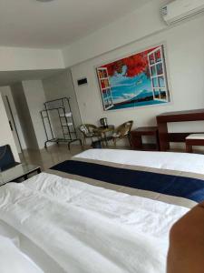 Postel nebo postele na pokoji v ubytování 海鑫宾馆