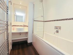 a bathroom with a shower and a sink and a mirror at Hawkrigg Cottage in Barbon +28 photos