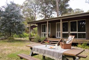 a picnic table in front of a house at Werriberri in Medlow Bath