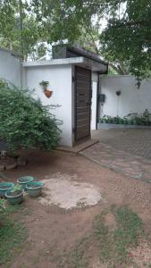 a small shed with a door in a yard at New Moon in Pannipitiya