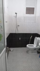 a bathroom with a toilet and a shower at New Moon in Pannipitiya
