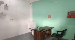 a room with a desk and a chair and a table at SPOT ON Pawan Restaurant & Dhabha in Phāphāmau