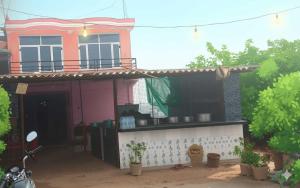 a house with a dog sitting in front of it at SPOT ON Pawan Restaurant & Dhabha in Phāphāmau