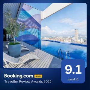 a tv screen with a view of a pool on a building at 22 Macalisterz George Town in George Town