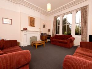 a living room with red furniture and a fireplace at YHA Hathersage - Partner in Hathersage