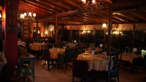 a dining room with tables and chairs and chandeliers at Treetops Park Hotel in Sile