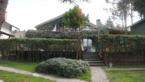 a house with a fence and stairs in front of it at Treetops Park Hotel in Sile