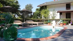a swimming pool with a table and a bench next to a house at Treetops Park Hotel in Sile