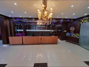 a large lobby with a chandelier and a bar at Hotel The NAS Residence in Dhaka