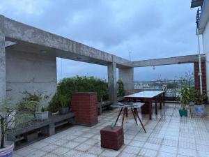 a patio with a table and benches on a building at Hotel The NAS Residence in Dhaka