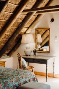 a bedroom with a desk and a mirror at Dove Cottage in Stanford