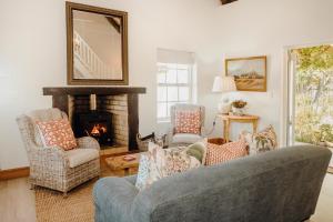 a living room with a couch and chairs and a fireplace at Dove Cottage in Stanford
