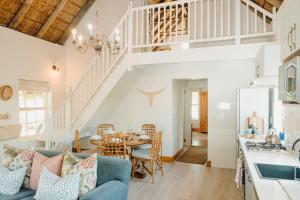 a kitchen and living room with a blue couch and a table at Dove Cottage in Stanford