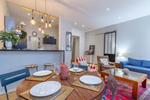 Le Barthou - T3 lumineux en centre-ville de Pau في بو: غرفة طعام وغرفة معيشة مع طاولة وكراسي +13 صورة