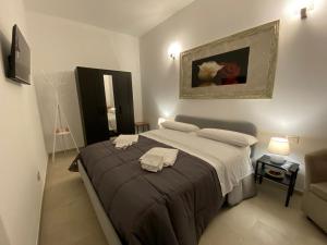 a bedroom with a bed with two towels on it at Il Campanile 2 in Fondi