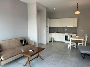 a living room with a couch and a table at Argo Summer Apartment in Agioi Apostoli