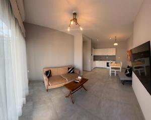 a living room with a couch and a table at Argo Summer Apartment in Agioi Apostoli