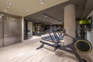 a gym with a row of treadmills and machines at The Central City - Luxury Serviced Residence in Luxembourg