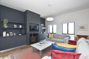 a living room with a couch and a fireplace at Caracal 54 in Yzerfontein