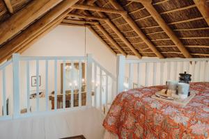 a bedroom with a bed in a room with wooden ceilings at Finchlea Cottage in Stanford