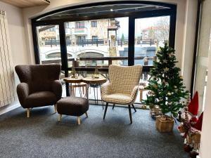 a room with chairs and a christmas tree and a window at Suite in Dream Bansko in Bansko +38 photos