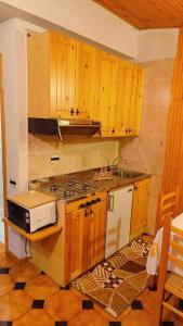 a kitchen with wooden cabinets and a stove top oven at Villa Anna Palumbo Sila in Torre Caprara +39 photos