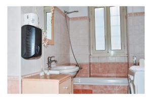 a bathroom with a tv and a tub and a toilet at La Dolce Sosta in Lido di Ostia