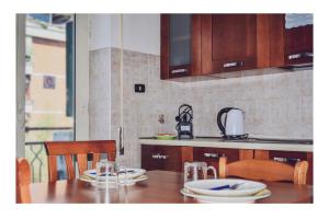 a kitchen with a table with plates on it at La Dolce Sosta in Lido di Ostia
