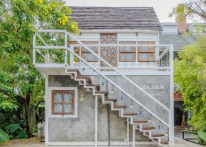 a house with stairs on the side of it at Perennial Resort in Nai Yang Beach