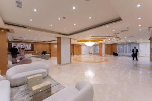 a lobby with couches and chairs in a building at Havana Holiday Homes Oud Metha in Dubai +36 photos