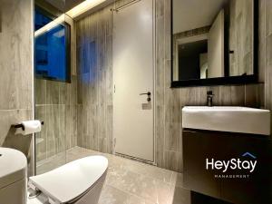 a bathroom with a toilet and a sink and a mirror at Antara Genting by HeyStay Management in Genting Highlands +48 photos