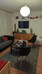 a living room with a couch and a table at Goldapartman Salgótarján in Salgótarján