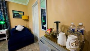 a dresser with a blue chair in a room at uPhondo Lodge in Bulawayo